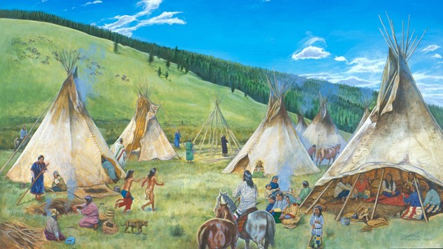 Several tepee poles in a meadow on a sunny day.